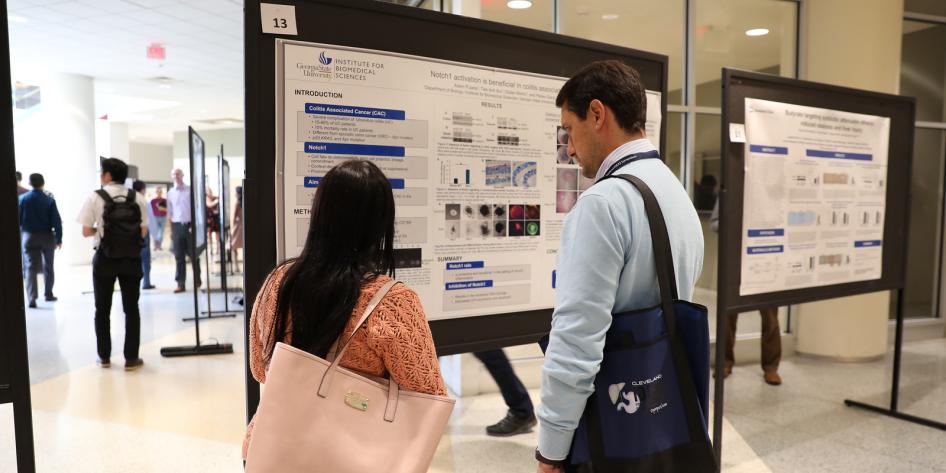 Two Researchers Review Poster