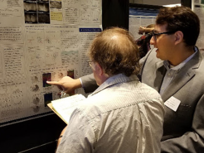 Two researchers look at research posters