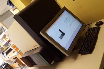 Image of HiScan Array Scanner on a workstation with dispay, keyboard and mouse within a lab environment