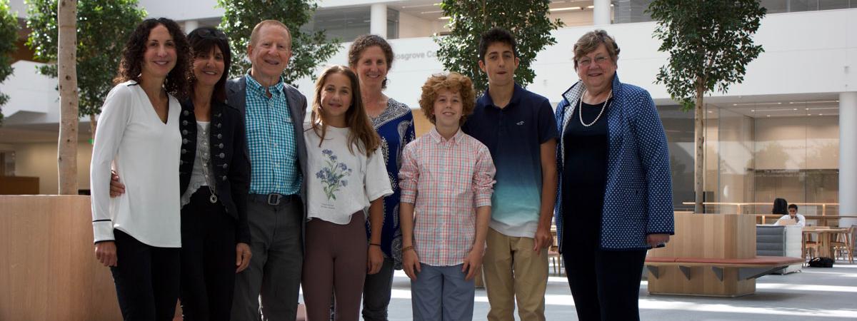 Photo lineup of Dr. Andrew B. Kaufman, his family and Dean Pamela Davis in the HEC