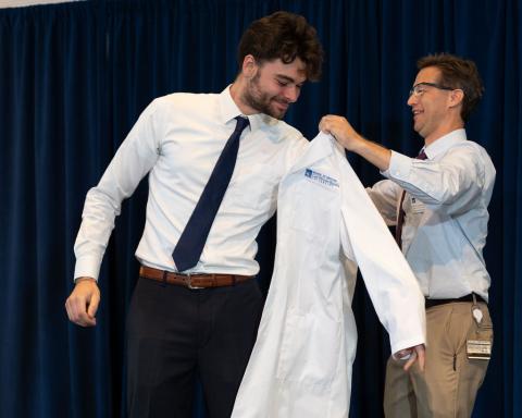 Student being given white coat