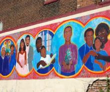 Mural on a brick wall with pictures of African-American families
