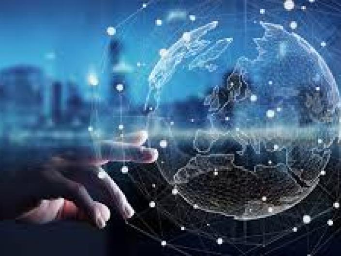 hand touching a hologram of the earth. In the background is a cityscape