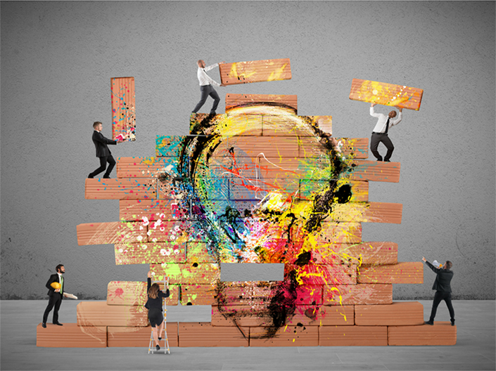 People working together with oversized blocks of wood to build a structure. Alight bulb and bright colors are superimposed