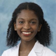 Raghnal, Aijah (woman with curly black hair in a white coat)