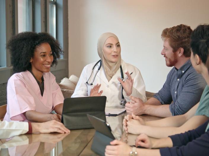 A group of diverse medical professionals discussing at a table