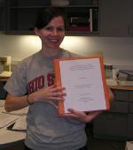 Erin holding a paper.