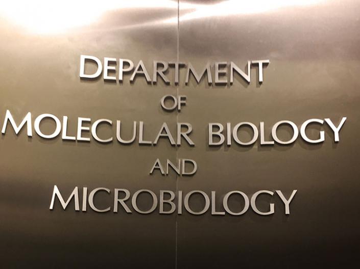 Sign of Department of Molecular Biology and Microbiology on the wall 
