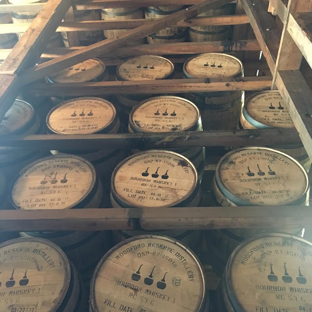 Five rows of wooden distillery barrels