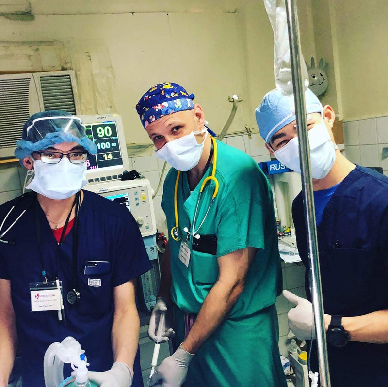 Male CWRU Master of Science in Anesthesia student with two medical providers in operating room