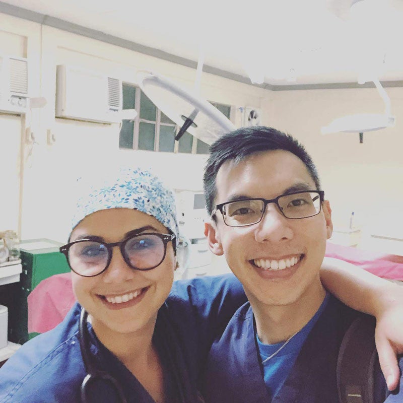 Two anesthesia students posing in scrubs