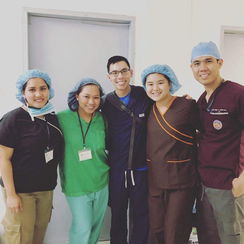Five anesthesia students and providers posing in scrubs