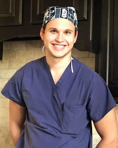 Male certified anesthesiologist assistant student in blue scrubs