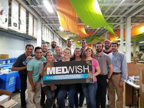 Group of Master of Science in Anesthesia students holding sign, reading MedWish Mark Your Mark