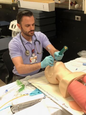 Male anesthesiologist assistant student practicing intubation