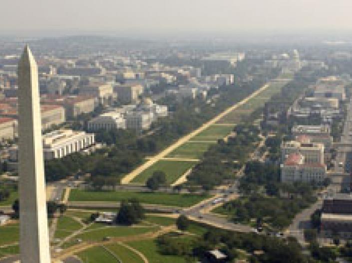 Image of panorama of Washington, DC USA with the upper half of the Washington Monument in the foreground