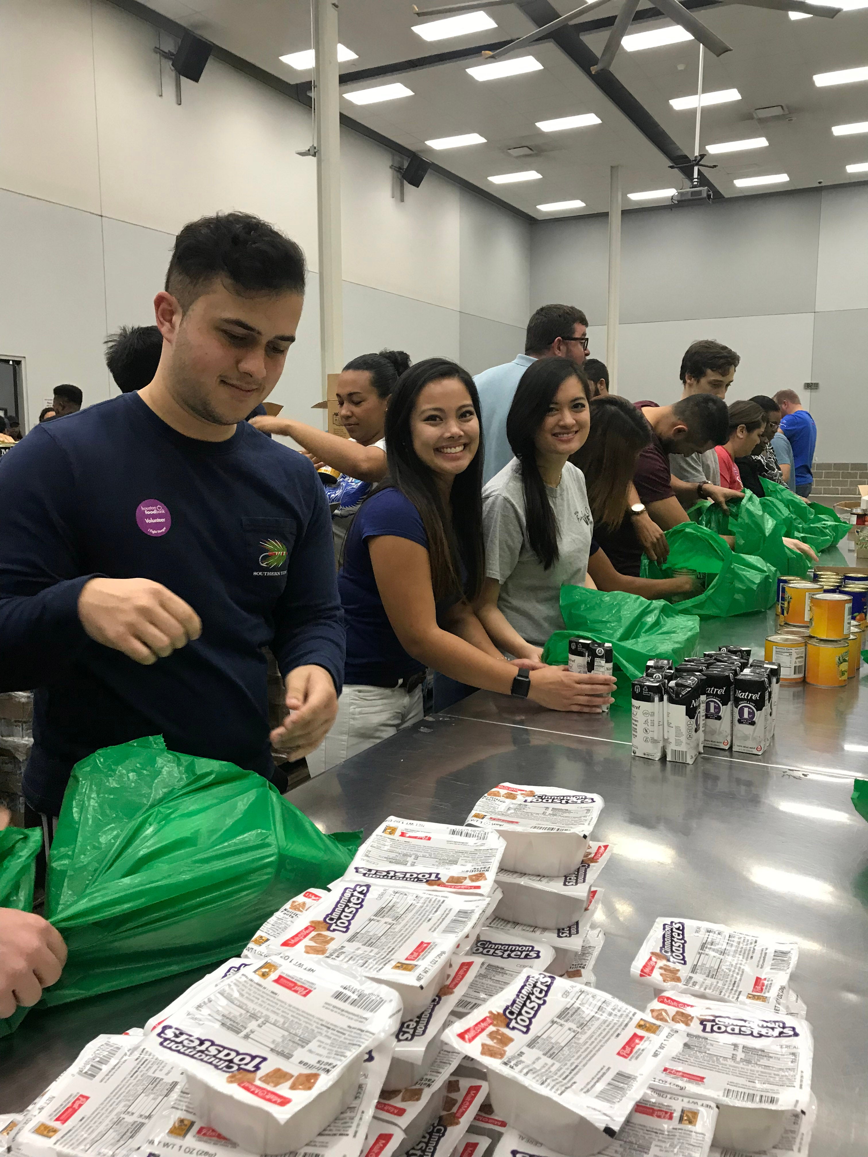 CWRU MSA Houston students in assembly line for packing bags