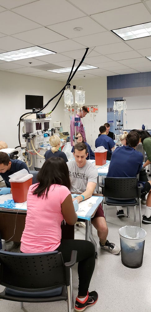 Group of CWRU Master of Science in Anesthesia students practice IVs in Washington, DC classroom
