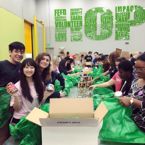 CWRU MSA Houston students packing green bags of food