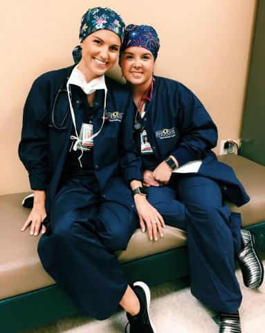 Two female Master of Science in Anesthesia students in scrubs