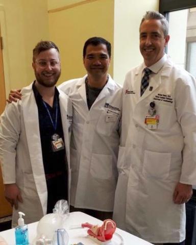 Three male anesthesiologist assistants wearing white coats
