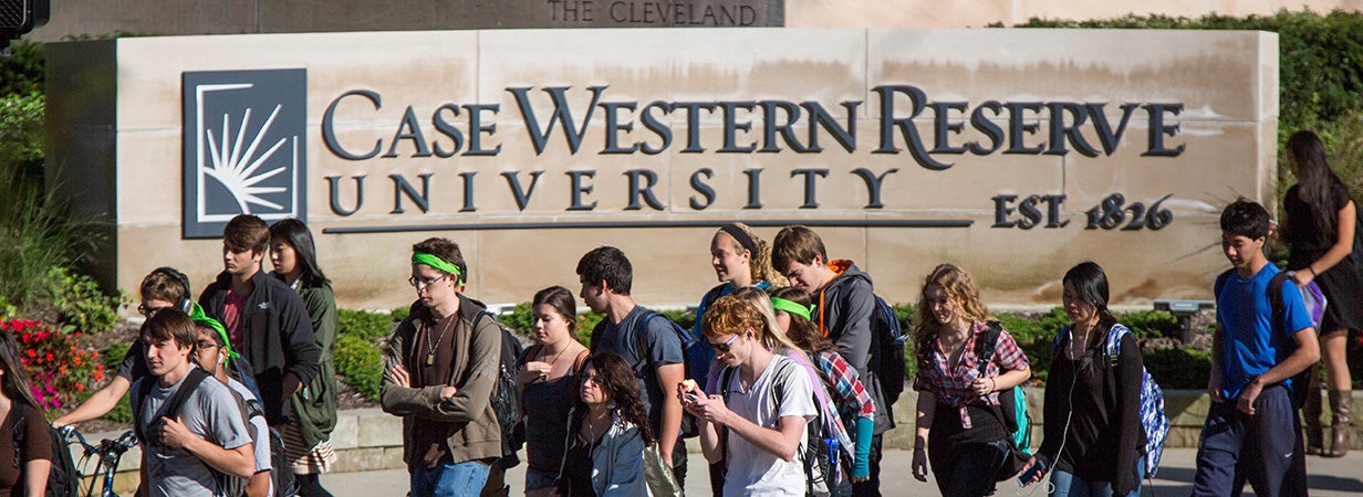 CWRU Students walking in front of a Case Western Reserve University sign