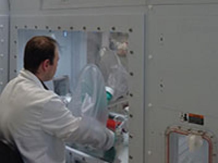 Male researcher working on a machine.