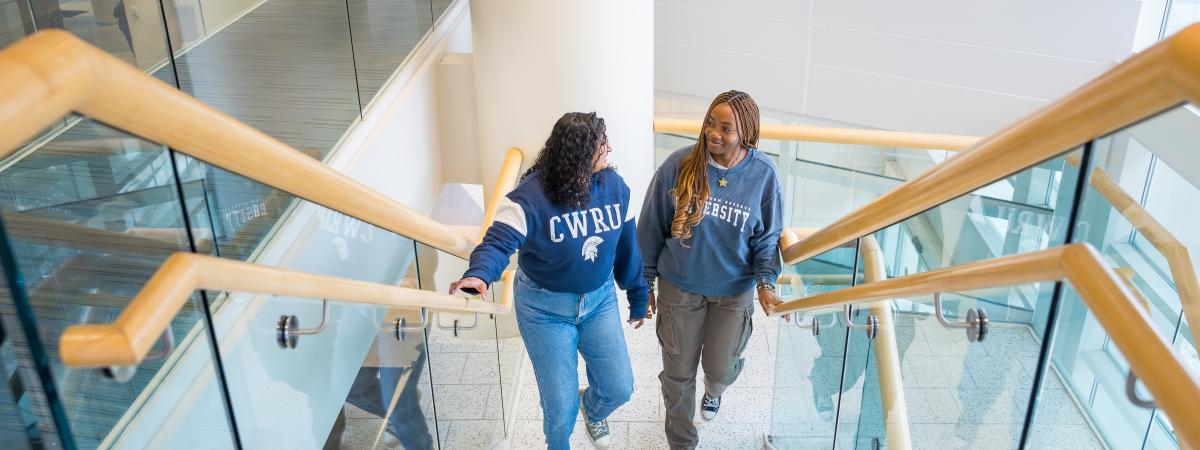 Two students walking up the stairs