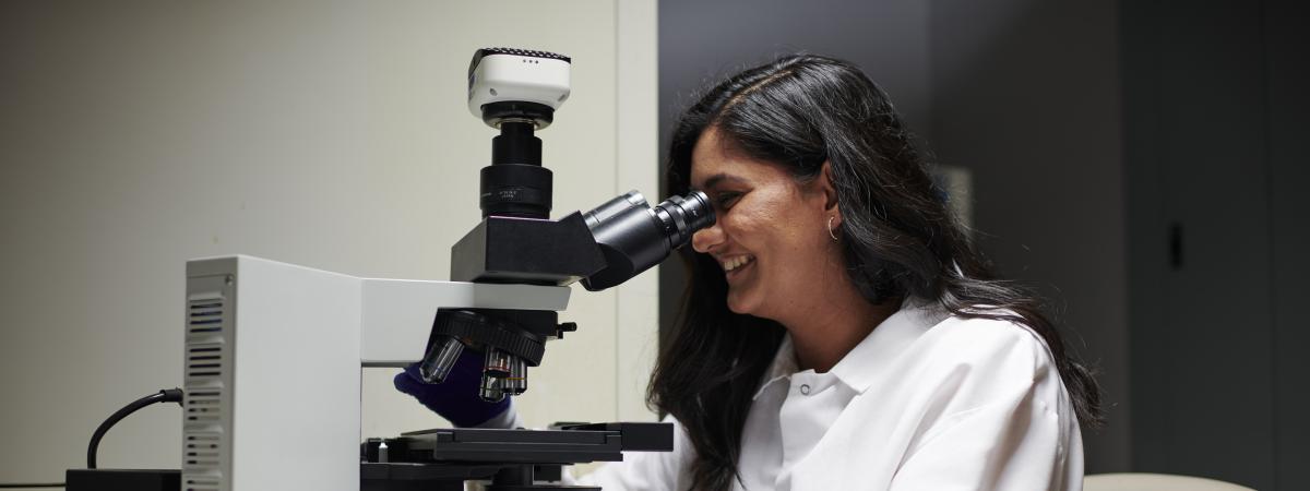 Student working with microscope