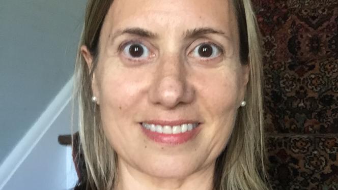 This is an image of a woman with brown hair and brown eyes