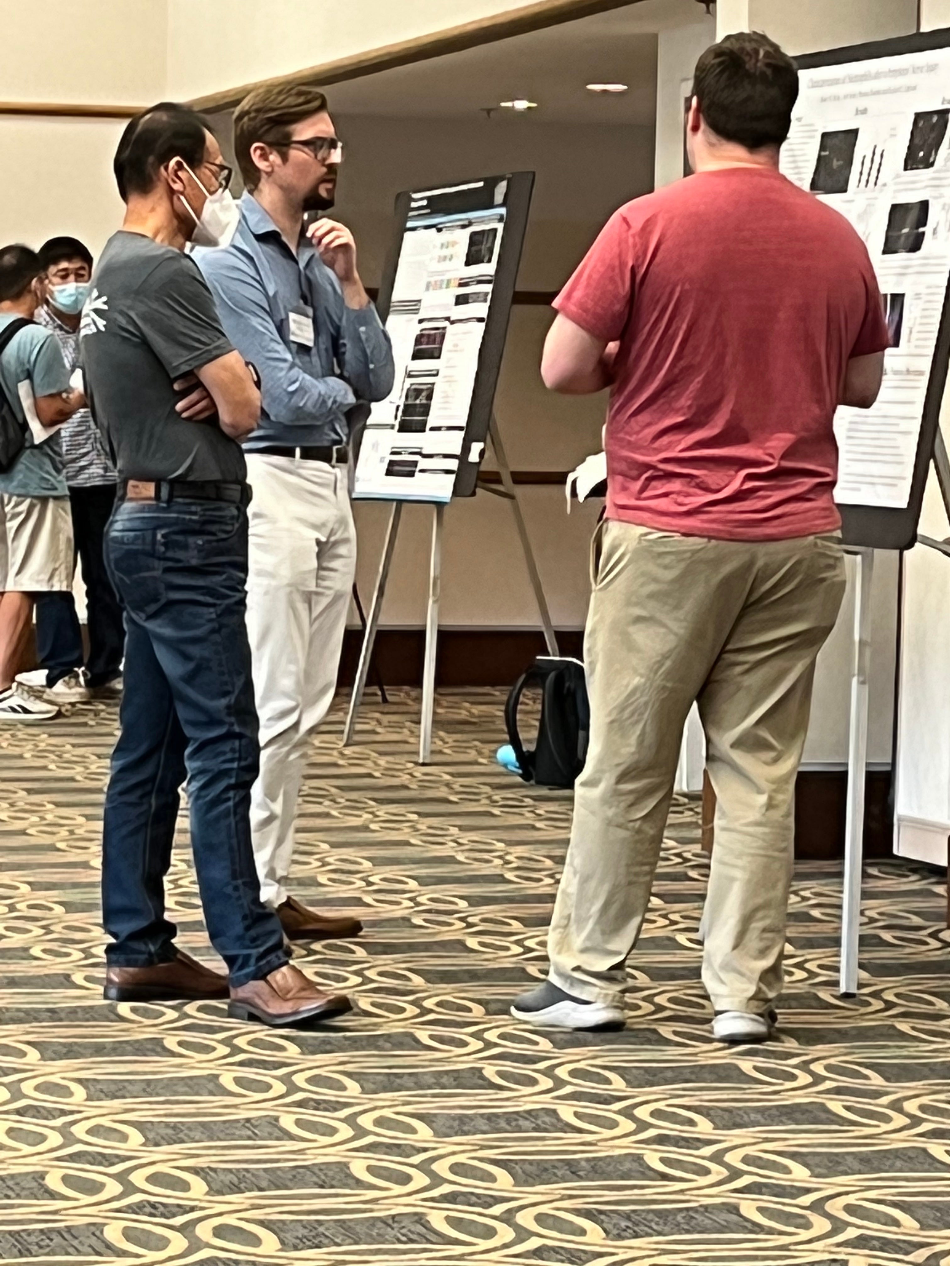 People looking at a research poster