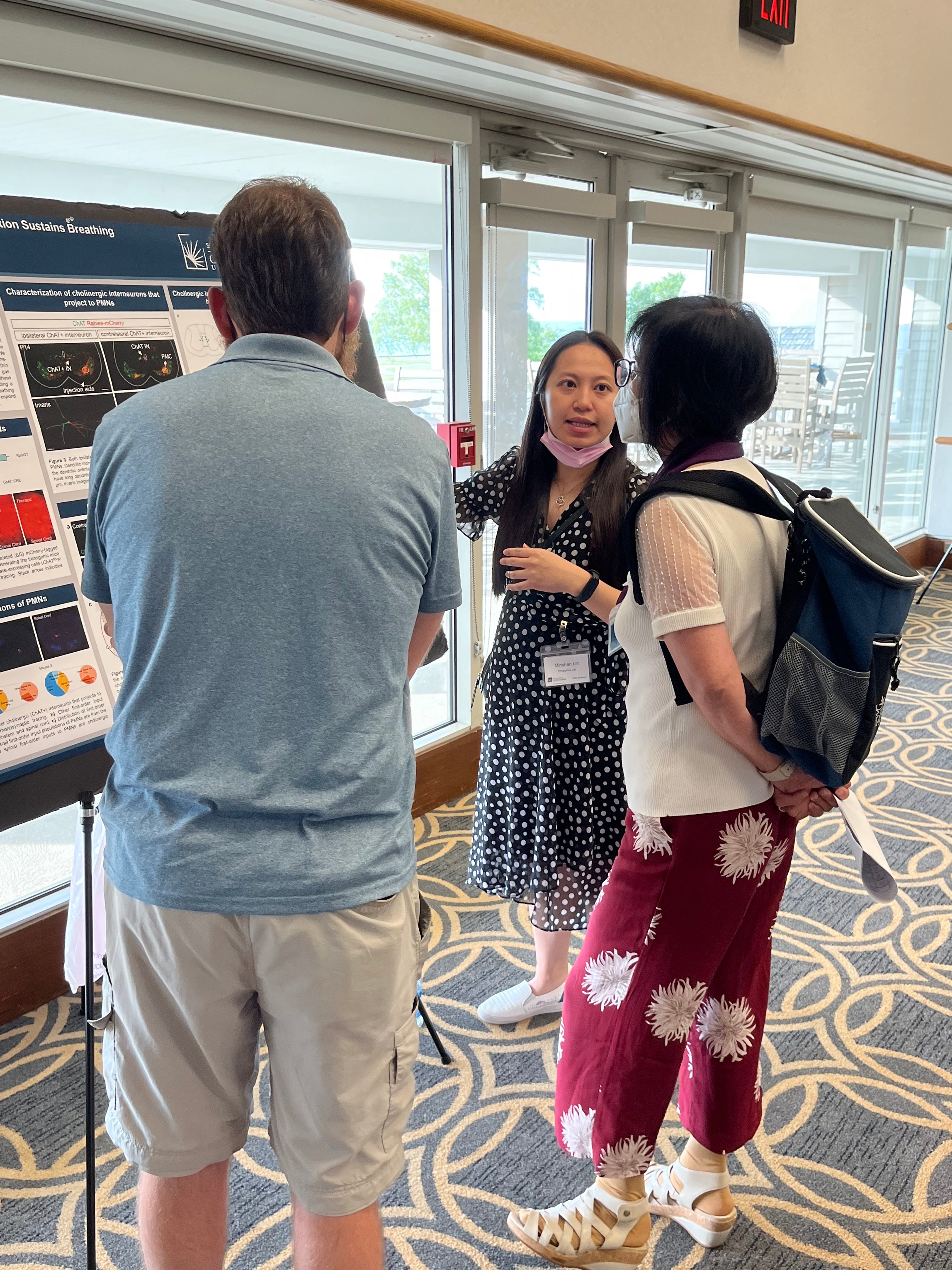 A researcher is presenting her research to two people