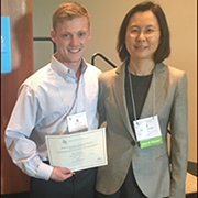 Image Logan Glosser holding award certificate with Dr. James Swain, Associate Professor in the Case Western Reserve University School of Medicine Department of Nutrition