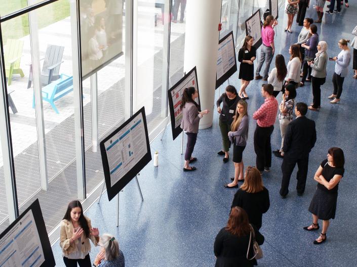 Attendees view a student poster session during the Gut Microbiome Symposium