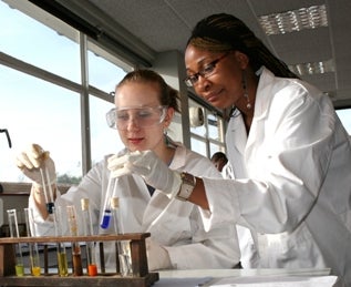 Two female lab technicians working with chemicals