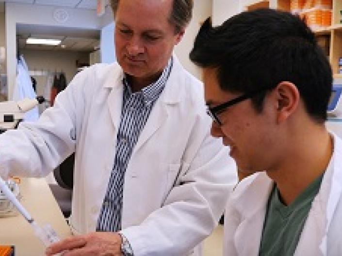 A professor and a student working in a lab