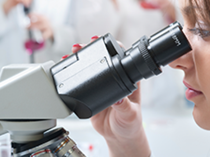 Student looking through a microscope