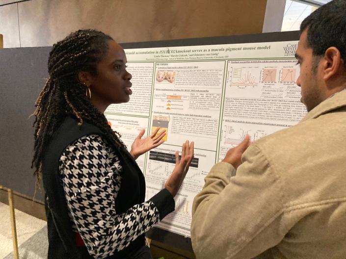 Students discussing poster presentations
