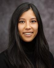 Headshot of Yuli Buckley in a black sweater