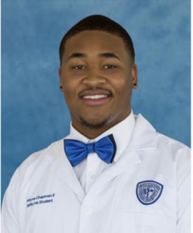 Dwayne Chapman II headshot in his whitecoat in front of a blue background