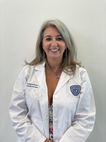 Francesca Russo in her whitecoat in front of a white wall