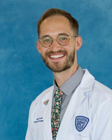 Heath Austin in his whitecoat headshot in front of a blue background