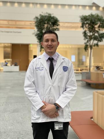 Kris Cutaj in his whitecoat in the HEC Building at Case Western Reserve University