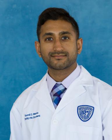 Somil Mehta in his whitecoat headshot in front of a blue background