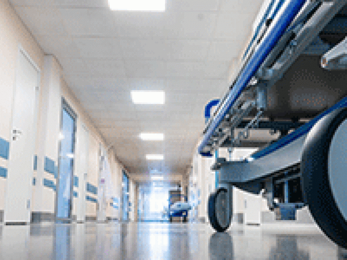 Hallway of a healthcare setting with a bed