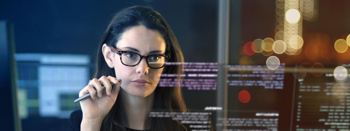 Close up of a professional woman looking at data on a virtual scree