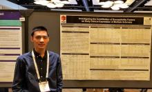 Justin Yu of Case Western Reserve standing with research poster