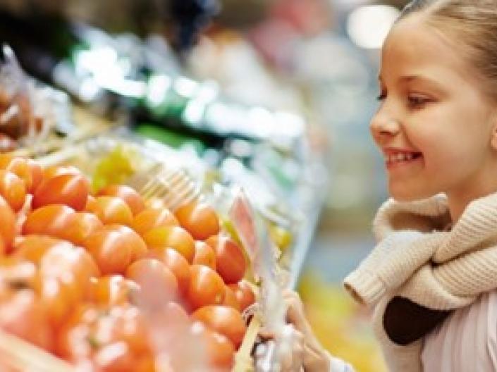 Young girl looking at produce