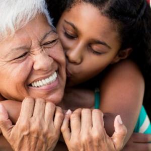 Grandmother and granddaughter embrace