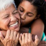 Grandmother and granddaughter embrace